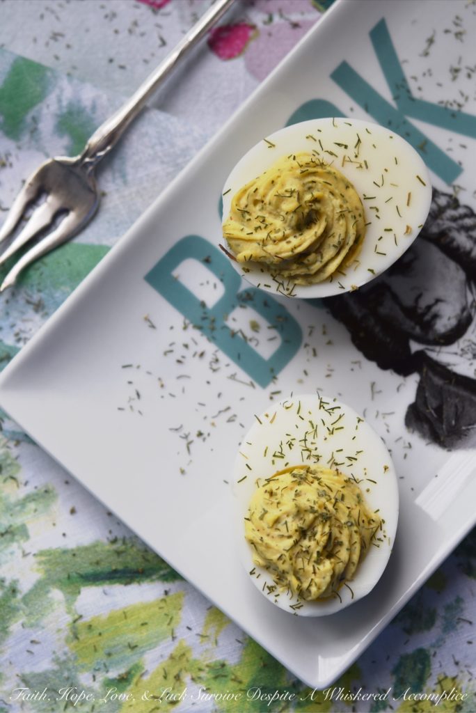 Dill Weed Deviled Eggs - Make ordinary deviled eggs "egg"traordinary with the addition of dill weed, pickle juice, mayonnaise, Dijon mustard, salt, pepper, and just a touch of sugar.