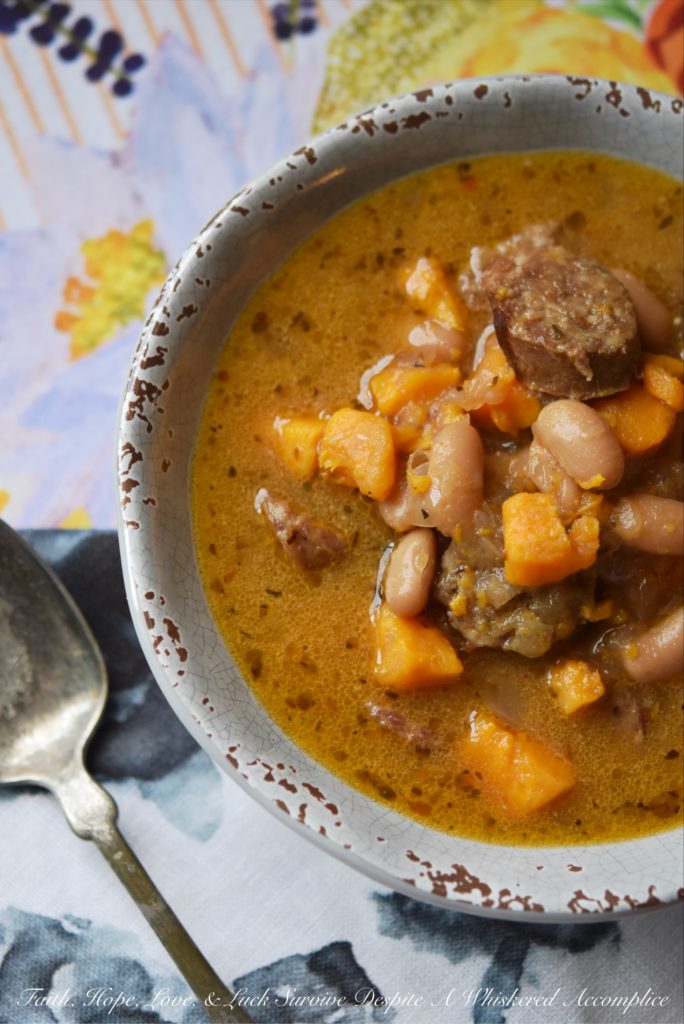 Cajun Bratwurst Slow-Cooker Soup - This bratwurst slow-cooker soup, containing cannellini beans and sweet potatoes, has just the right amount of Cajun kick with just a touch of sweetness. A can of light coconut milk also helps give this slow-cooked soup a hint of richness without making it too fattening.