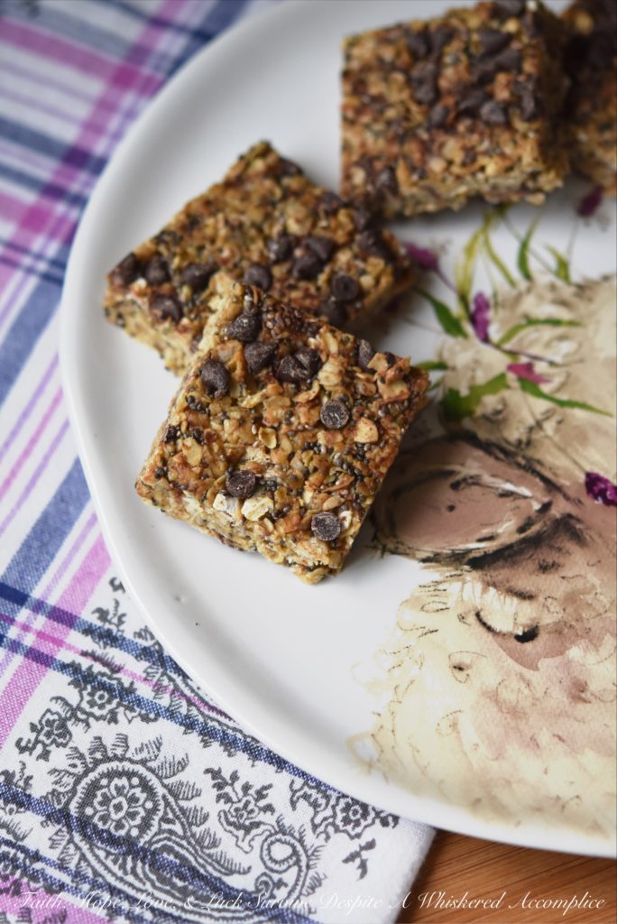 Peanut Butter & Chocolate Chip Granola Squares - These healthier homemade granola squares are incredibly easy to make at home with just a few simple ingredients. You’ll love the chewy texture from quick-cooking oats, the boost of nutrition from chia seeds, and the satisfying flavor of creamy peanut butter. A drizzle of honey provides a touch of sweetness, and a scattering of mini chocolate chips makes them irresistibly good.