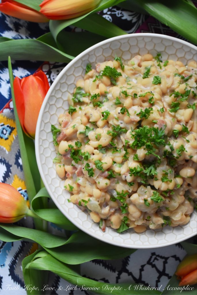 Creamy Southern Navy Beans with Bacon - While these creamy navy beans with bacon may take a little bit of time to make, either on a stovetop or with the help of a pressure cooker, they are more than worth the effort. I guarantee you're totally gonna fall in love with this flavorful southern side dish.