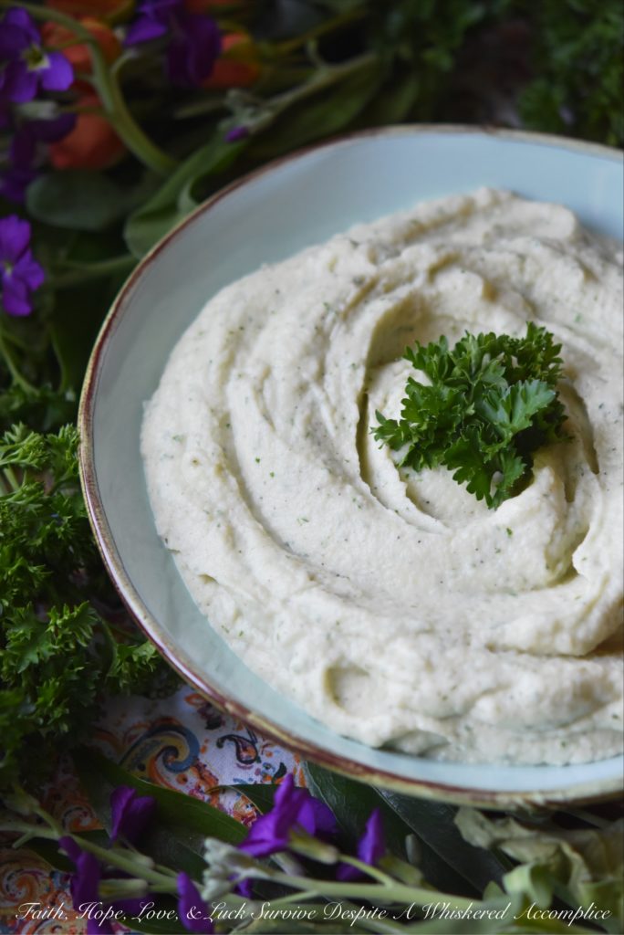 Creamy Mashed Cauliflower with Asiago & Parsley - Asiago and fresh parsley help turn this healthier mashed potato alternative into a flavorful side dish. Your family will fall in love with this creamy mashed cauliflower and you'll love just how quick and easy it is to make.
