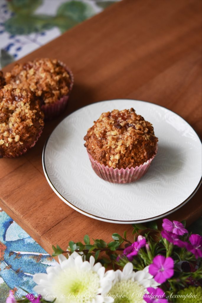 Strawberry Rhubarb Jam Oatmeal Muffins - Strawberry rhubarb jam lends a sweet fruity flavor to these delicious muffins sprinkled with just a touch of brown sugar, butter, and oatmeal crumble topping. The combination of jam and crunchy topping makes these muffins the perfect way to start your morning.