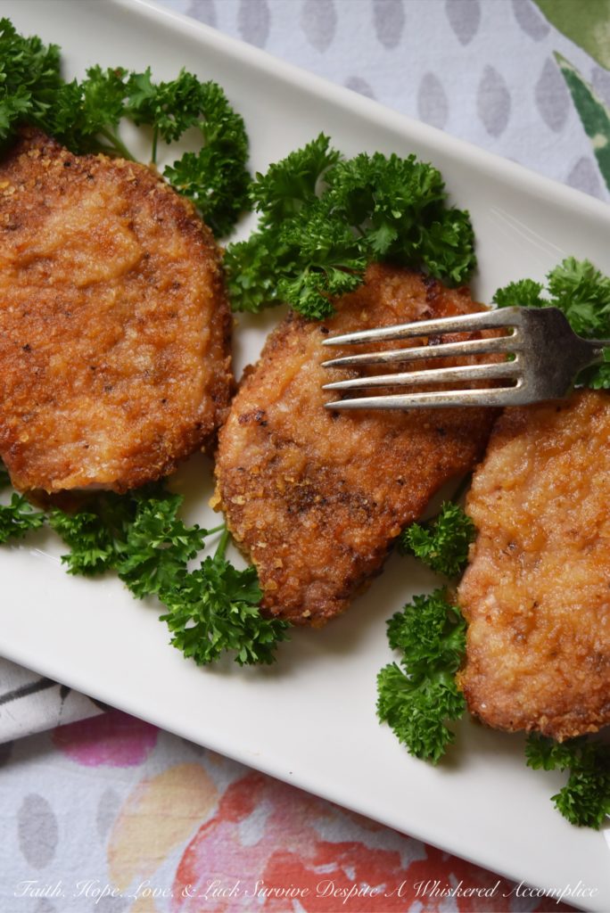 Baked BBQ Potato Chip Crusted Pork Chops - Flavorful baked pork chops are only a few simple ingredients away. Crushed BBQ potato chips, salt, pepper, paprika, and a little bit of olive oil are all you need to turn ordinary bland boneless pork chops into something unforgettable.