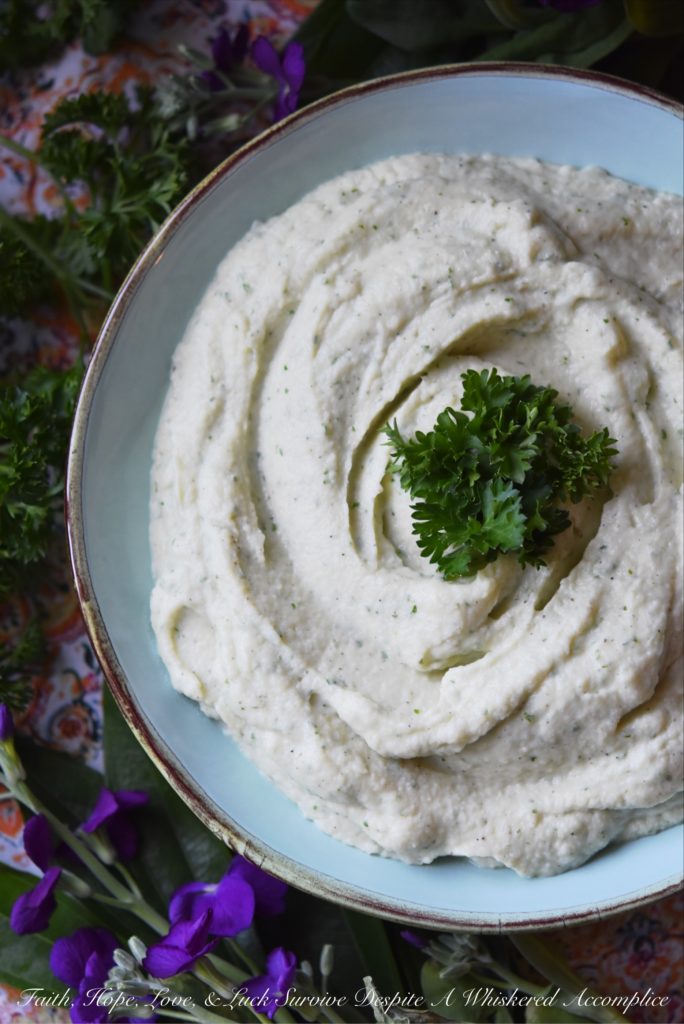 Creamy Mashed Cauliflower with Asiago & Parsley - Asiago and fresh parsley help turn this healthier mashed potato alternative into a flavorful side dish. Your family will fall in love with this creamy mashed cauliflower and you'll love just how quick and easy it is to make.