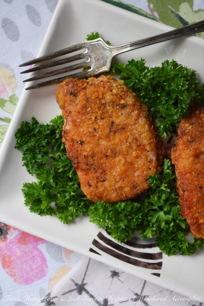 Baked BBQ Potato Chip Crusted Pork Chops - Flavorful baked pork chops are only a few simple ingredients away. Crushed BBQ potato chips, salt, pepper, paprika, and a little bit of olive oil are all you need to turn ordinary bland boneless pork chops into something unforgettable.
