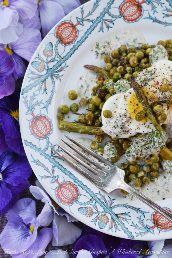 Creamy Roasted Asparagus & Pea Salad - This warm roasted vegetable salad uses fresh asparagus, frozen peas, and garlic to create an absolutely unforgettable spring salad. Topped with sliced hard-boiled eggs and a creamy parsley and chive dressing, this salad is anything but boring.