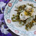 Creamy Roasted Asparagus & Pea Salad - This warm roasted vegetable salad uses fresh asparagus, frozen peas, and garlic to create an absolutely unforgettable spring salad. Topped with sliced hard-boiled eggs and a creamy parsley and chive dressing, this salad is anything but boring.