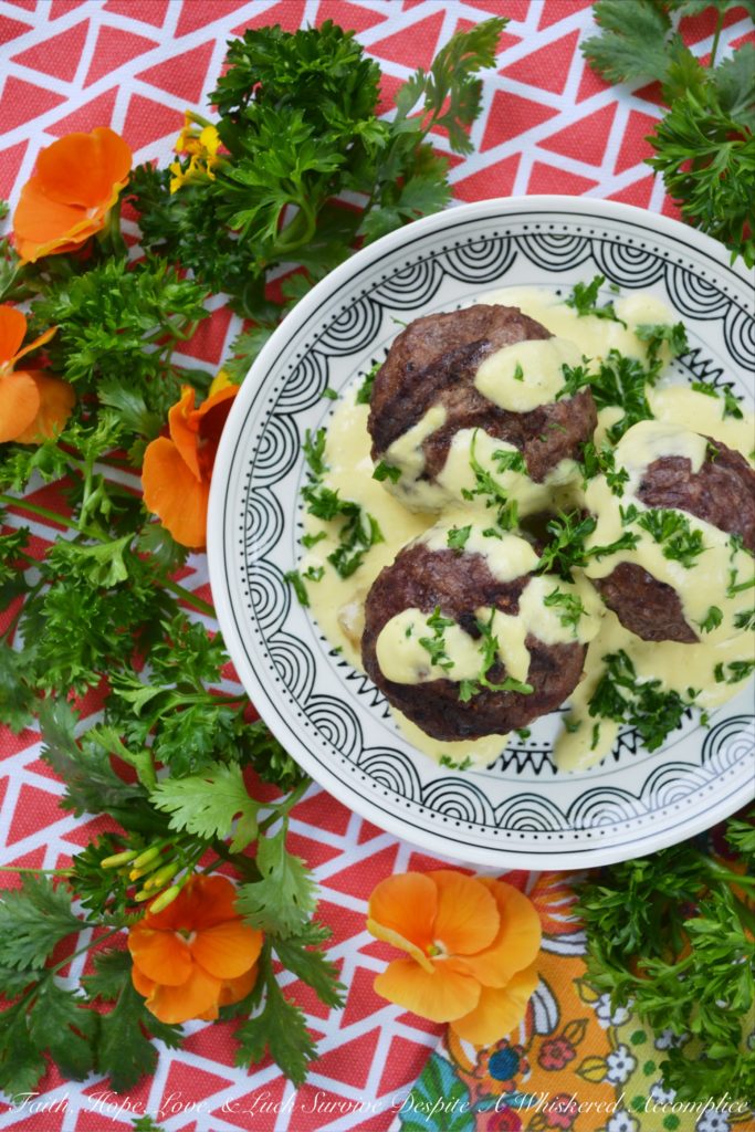 Grilled Stuffed Meatballs with Pineapple Sauce - It's always nice to have an alternative to the standard grilled hamburger during the summer months. These cheese-stuffed meatballs are seasoned with steak seasoning, grilled, and then served with a sweet pineapple sauce made out of fresh pineapple, mayonnaise, and dijon mustard.