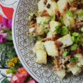 Summer BBQ Bacon Potato Salad - Say "Hello" to summertime with this simple yet super flavorful potato salad. There's a full pound of bacon folded into this summer side dish, which is first liberally brushed with barbecue sauce and then baked until browned and perfectly crispy. After you add a little bit of mayonnaise, black pepper, and finely chopped scallions, this potato salad will be ready to head to your next BBQ, picnic, or summer cookout.