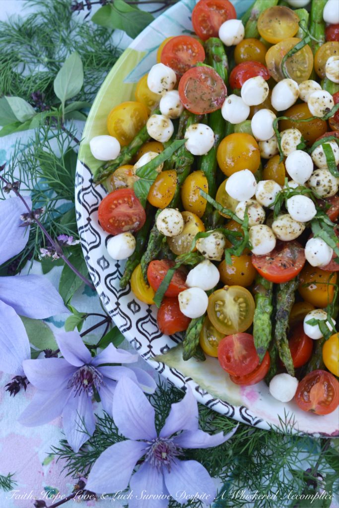 Grilled Asparagus Summer Caprese Salad - Grilled asparagus is topped with halved cherry tomatoes and fresh mozzarella in this room-temperature fresh summer salad. After being drizzled with a simple homemade balsamic vinegar dressing, this asparagus caprese salad instantly transforms into an appetizer, salad, or side dish perfect for your next BBQ, picnic, or cookout.