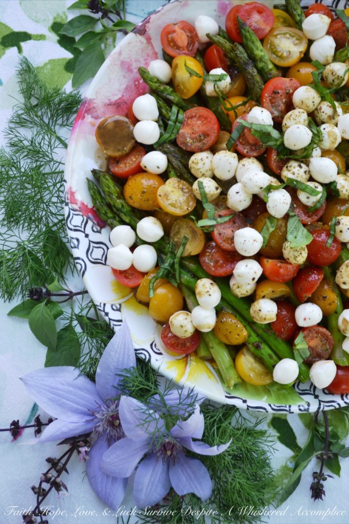 Grilled Asparagus Summer Caprese Salad - Grilled asparagus is topped with halved cherry tomatoes and fresh mozzarella in this room-temperature fresh summer salad. After being drizzled with a simple homemade balsamic vinegar dressing, this asparagus caprese salad instantly transforms into an appetizer, salad, or side dish perfect for your next BBQ, picnic, or cookout.