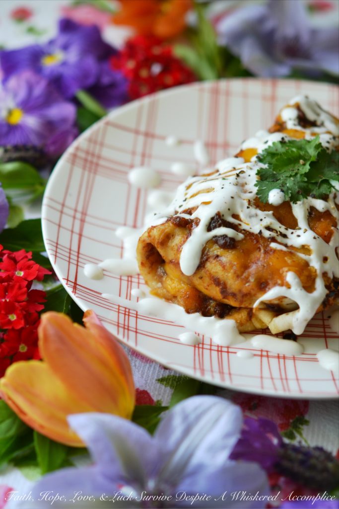 Ancho Chile Lime Pork Enchiladas | Dried ancho chile peppers and fresh lime juice make these flavorful pork enchiladas truly something special without burning off all of your taste buds. These cheddar cheese-covered enchiladas are sweet, tart, smoky, and packed with flavor. They're perfect for people who aren't crazy about spice but still want to enjoy some delicious Mexican food.