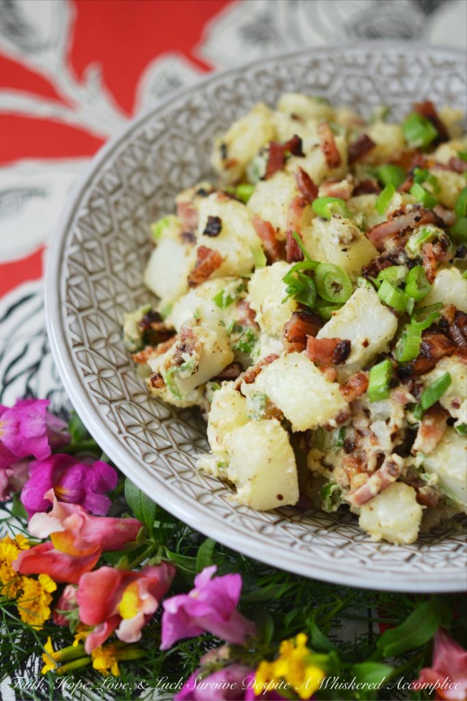 Summer BBQ Bacon Potato Salad - Say "Hello" to summertime with this simple yet super flavorful potato salad. There's a full pound of bacon folded into this summer side dish, which is first liberally brushed with barbecue sauce and then baked until browned and perfectly crispy. After you add a little bit of mayonnaise, black pepper, and finely chopped scallions, this potato salad will be ready to head to your next BBQ, picnic, or summer cookout.