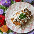 Ancho Chile Lime Pork Enchiladas | Dried ancho chile peppers and fresh lime juice make these flavorful pork enchiladas truly something special without burning off all of your taste buds. These cheddar cheese-covered enchiladas are sweet, tart, smoky, and packed with flavor. They're perfect for people who aren't crazy about spice but still want to enjoy some delicious Mexican food.