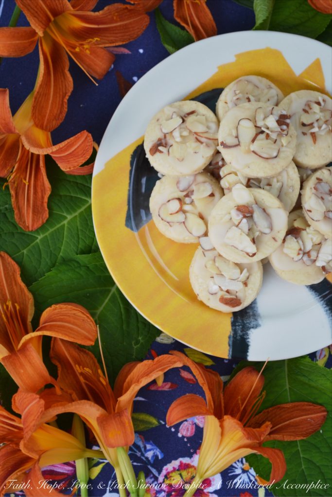 Almond & Orange Glazed Shortbread Cookies - A few teaspoons of orange extract in both the dough and glaze of these almond-topped buttery shortbread cookies helps to give these delicate glazed shortbread cookies a lovely orange flavor that is not too overwhelming or overly-sweet.