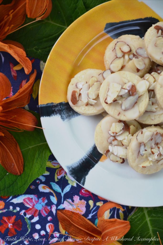 Almond & Orange Glazed Shortbread Cookies - A few teaspoons of orange extract in both the dough and glaze of these almond-topped buttery shortbread cookies helps to give these delicate glazed shortbread cookies a lovely orange flavor that is not too overwhelming or overly-sweet.