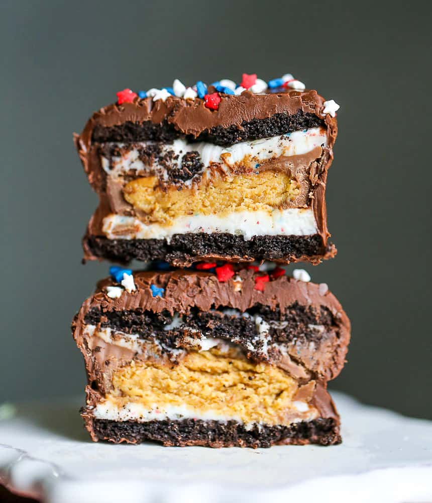 4th of July - Chocolate Dipped Peanut Butter Cup Double Stuffed Oreos - The Baking ChocolaTess - The month of July is all about summer cookouts, picnics, and barbecues. We're sharing our favorite red, white, and blue patriotic themed recipes to help get you in the 4th of July spirit.