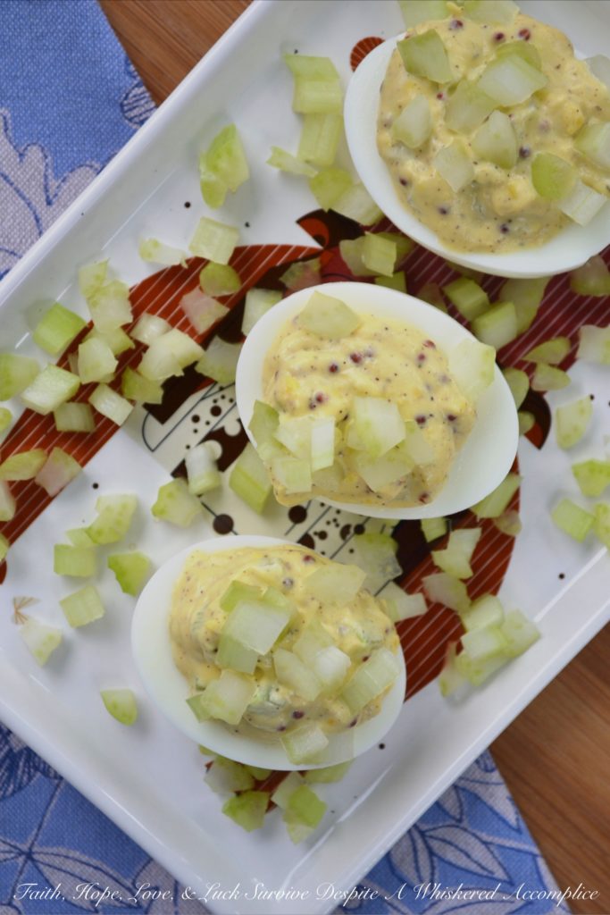 Celery & Whole Mustard Deviled Eggs - With five simple ingredients, you can kick up your deviled eggs this summer just in time to enjoy at your next cookout, picnic, or barbecue. These deviled eggs have a lovely crunch thanks to the finely diced celery both in the filling and used as a garnish, as well as tons of flavor from the whole Dijon mustard used to make the filling. These little guys are so simple to make but they are definitely anything but boring.