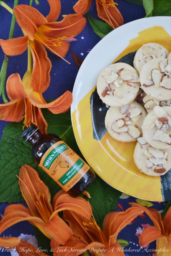 Almond & Orange Glazed Shortbread Cookies - A few teaspoons of orange extract in both the dough and glaze of these almond-topped buttery shortbread cookies helps to give these delicate glazed shortbread cookies a lovely orange flavor that is not too overwhelming or overly-sweet.