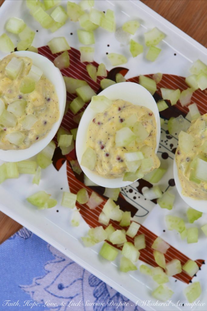 Celery & Whole Mustard Deviled Eggs - With five simple ingredients, you can kick up your deviled eggs this summer just in time to enjoy at your next cookout, picnic, or barbecue. These deviled eggs have a lovely crunch thanks to the finely diced celery both in the filling and used as a garnish, as well as tons of flavor from the whole Dijon mustard used to make the filling. These little guys are so simple to make but they are definitely anything but boring.