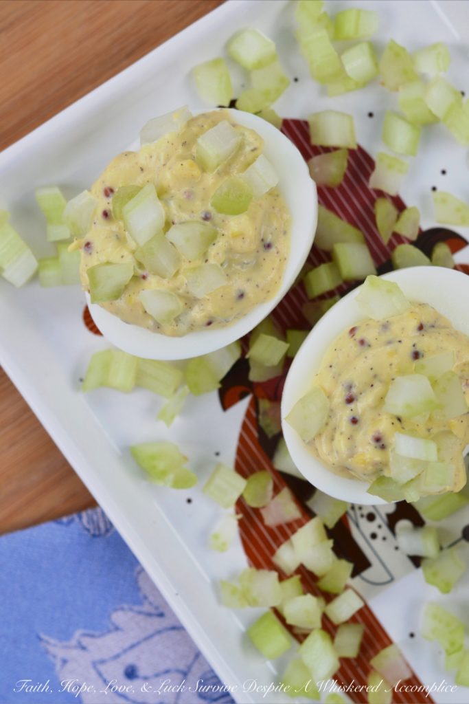Celery & Whole Mustard Deviled Eggs - With five simple ingredients, you can kick up your deviled eggs this summer just in time to enjoy at your next cookout, picnic, or barbecue. These deviled eggs have a lovely crunch thanks to the finely diced celery both in the filling and used as a garnish, as well as tons of flavor from the whole Dijon mustard used to make the filling. These little guys are so simple to make but they are definitely anything but boring.