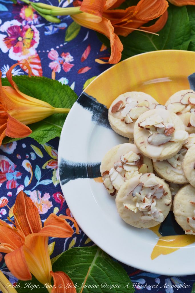 Almond & Orange Glazed Shortbread Cookies - A few teaspoons of orange extract in both the dough and glaze of these almond-topped buttery shortbread cookies helps to give these delicate glazed shortbread cookies a lovely orange flavor that is not too overwhelming or overly-sweet.