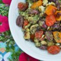 Oven-Roasted Cauliflower & Tomato Salad - Oven-roasted cauliflower and cherry tomatoes are transformed into a Mediterranean summer side salad, by adding homemade basil pesto sauce and kalamata olives. The basil pesto sauce is easy to make by just tossing fresh basil, pumpkin seeds or pepitas, olive oil, red wine vinegar, salt, and pepper into a food processor. This is a simple recipe that really bumps up the flavor of fresh summer produce.