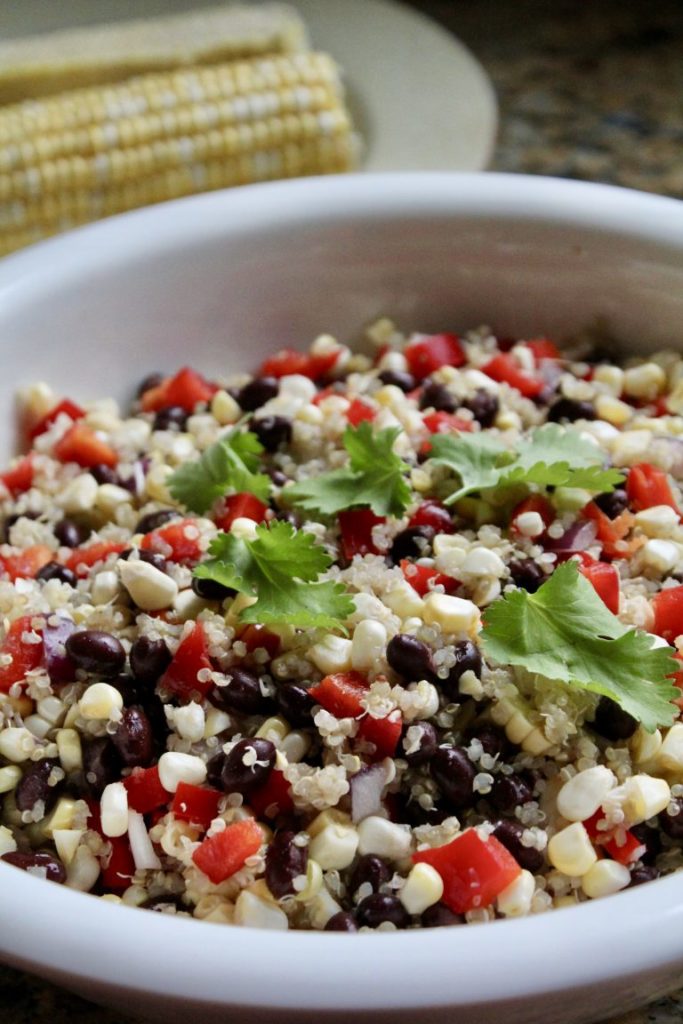 Sweet Corn and Bean Quinoa Salad - Girl Gone Mom - August 2018 Recipe Round-Up - For the month of August, we're sharing all of our favorite summertime recipes to make for a backyard barbecue, picnic, or cookout. After all, the warm summer weather won't stick around forever, so we need to spend as much time outdoors as possible before autumn arrives.