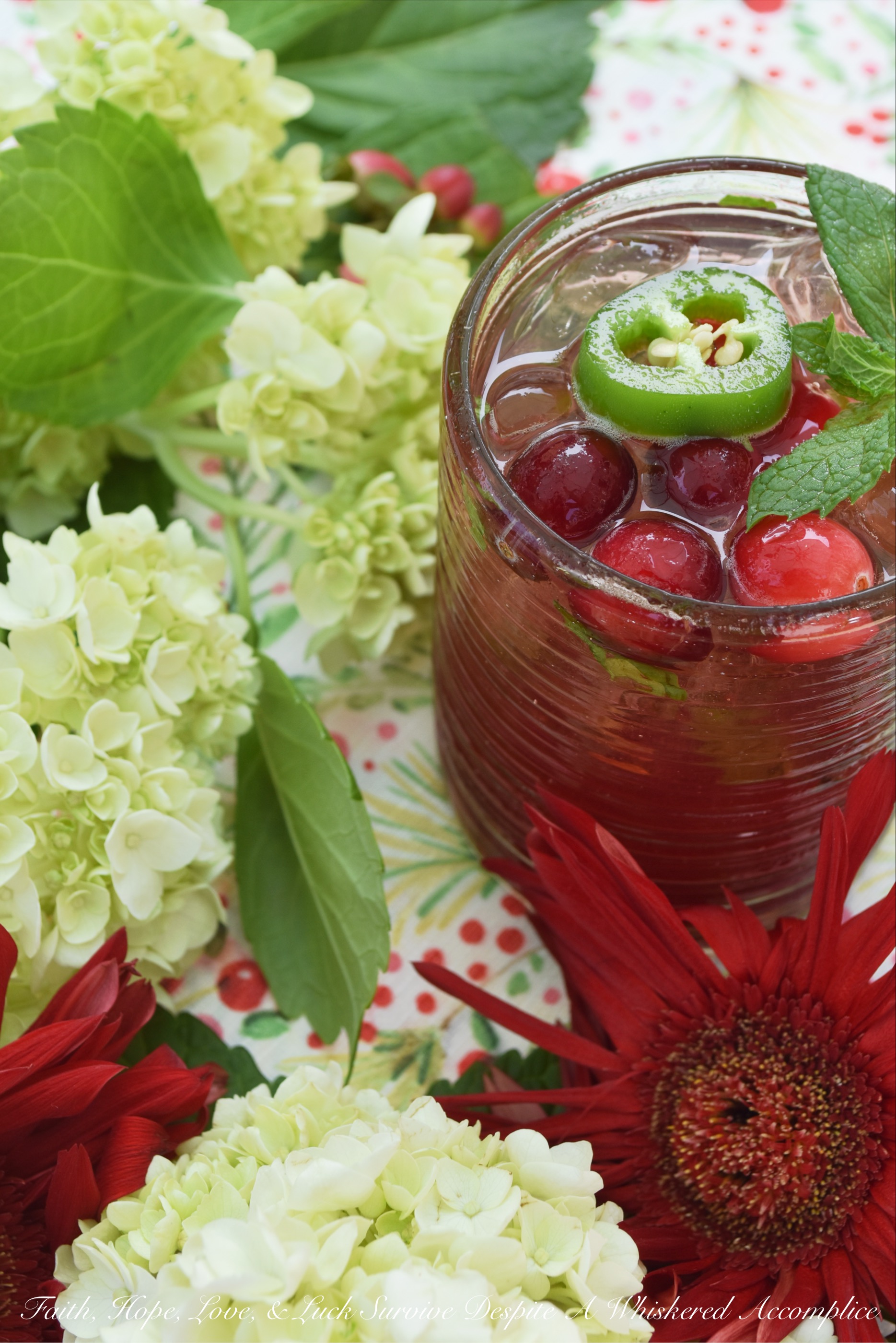 Spicy Cranberry & Jalapeño Mint Juleps - Add a little bit of spice to your happy hour with this cranberry and jalapeño infused mint julep. It uses a homemade sweet and spicy cranberry jalapeño jam sauce in lieu of sugar so that your cocktail has just the right amount of sugar and heat. Simply add a bit of fresh mint, bourbon, and sparkling water or club soda to it for the perfect cocktail hour worthy drink.