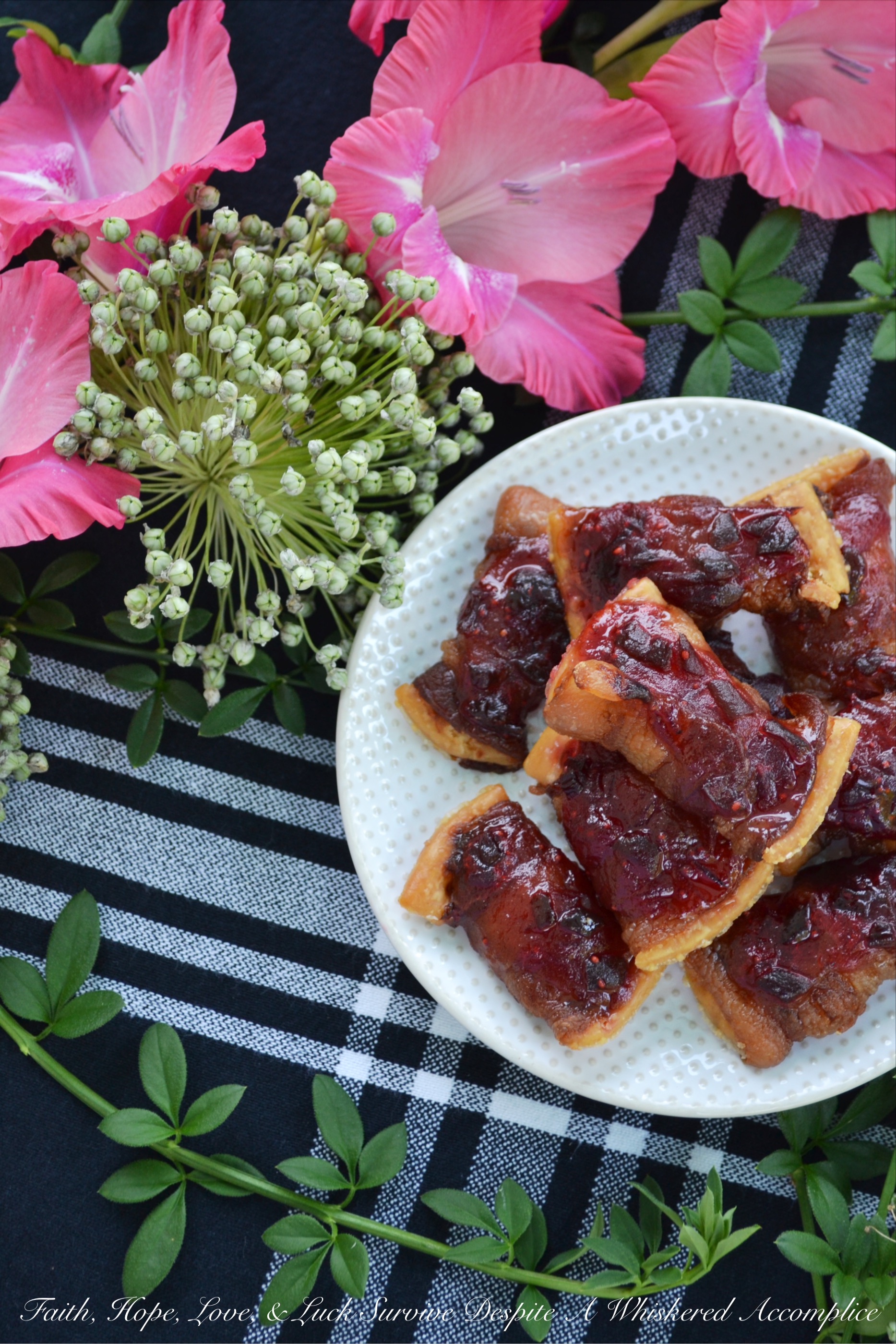 Bacon-Wrapped Cranberry Jalapeño Crackers - These may just be THE BEST APPETIZER you will ever eat. Buttery crackers are first wrapped in bacon before being topped with a sweet and spicy cranberry jalapeño jam sauce. To make these crackers even spicier, you can either top them with finely diced or thinly sliced additional jalapeño. Make a batch of the jam sauce ahead of time and freeze it in small batches, so that you'll always have some ready when you're in the mood to make this tasty treat.