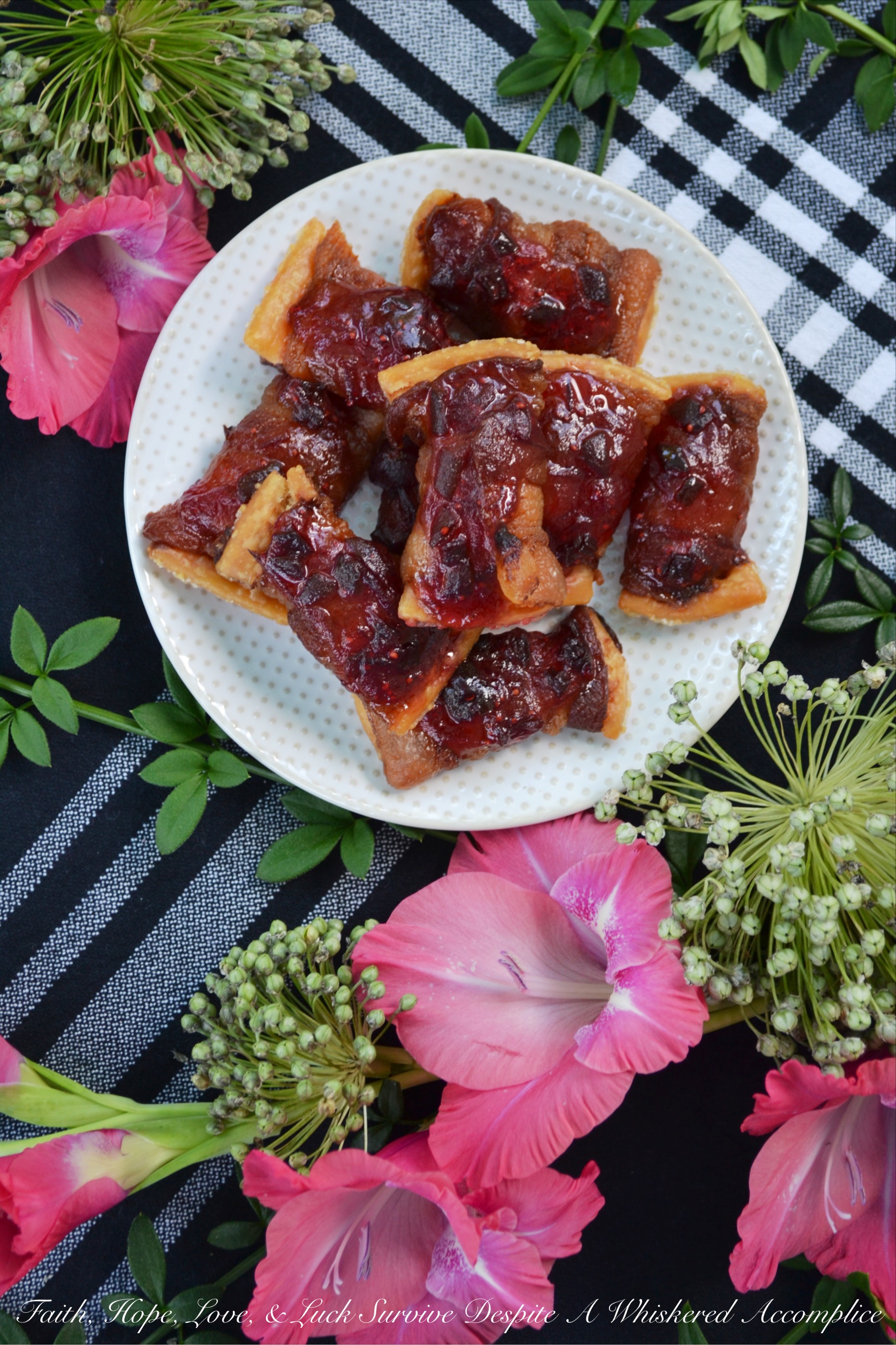Bacon-Wrapped Cranberry Jalapeño Crackers - These may just be THE BEST APPETIZER you will ever eat. Buttery crackers are first wrapped in bacon before being topped with a sweet and spicy cranberry jalapeño jam sauce. To make these crackers even spicier, you can either top them with finely diced or thinly sliced additional jalapeño. Make a batch of the jam sauce ahead of time and freeze it in small batches, so that you'll always have some ready when you're in the mood to make this tasty treat.