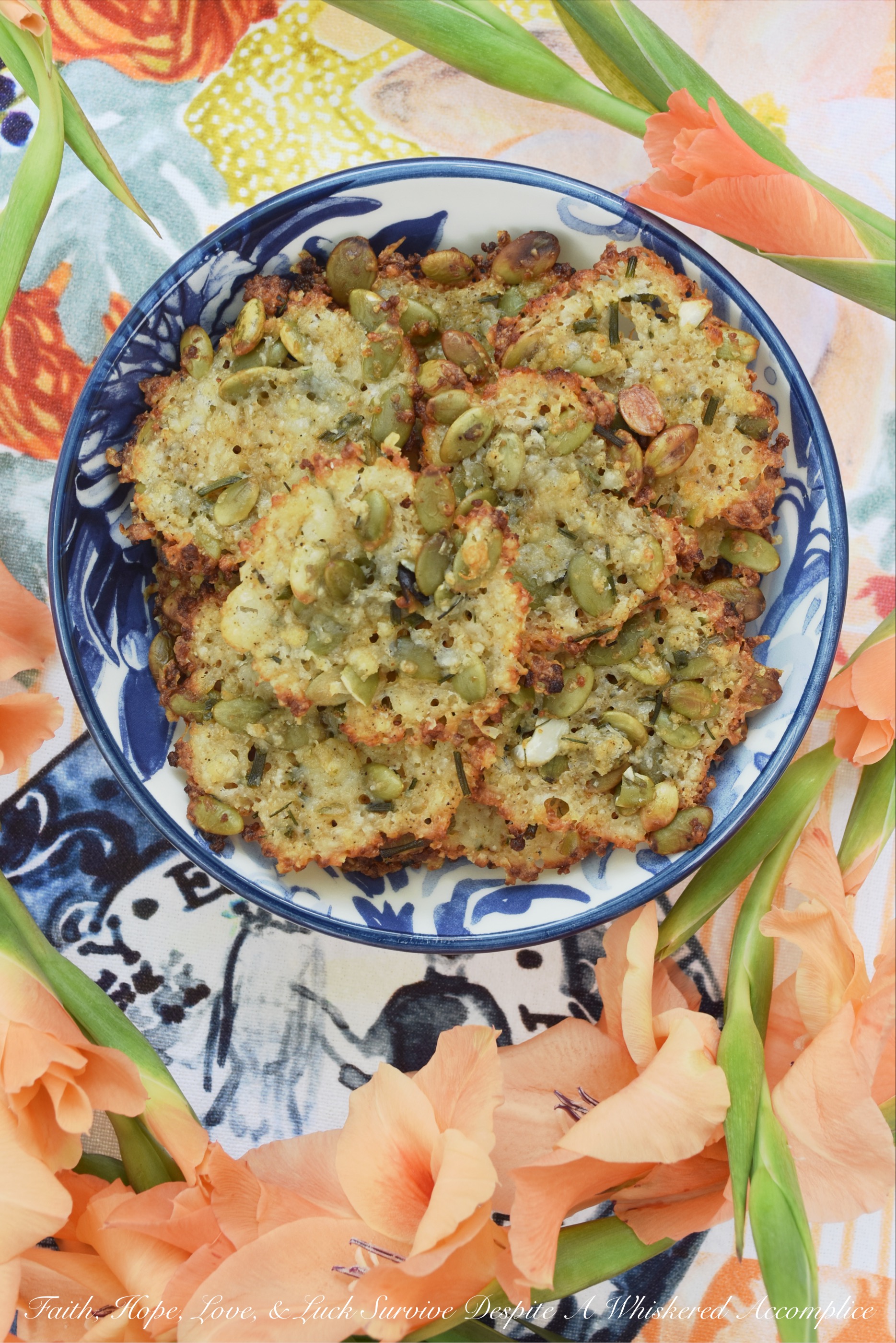 Spicy Latin Baked Cheese Crisps with Pepitas - Whether you eat these spicy baked cheese crisps alongside a comforting bowl of soup or on their own as an appetizer, I'm fairly certain that you're going to be in cheesy heaven. These little snack crackers contain both grated Romano and Asiago, along with a healthy dose of Queso Fresco, and with pepitas to give them a nice crunch and black pepper and cayenne some added heat, they're pretty much irresistible.