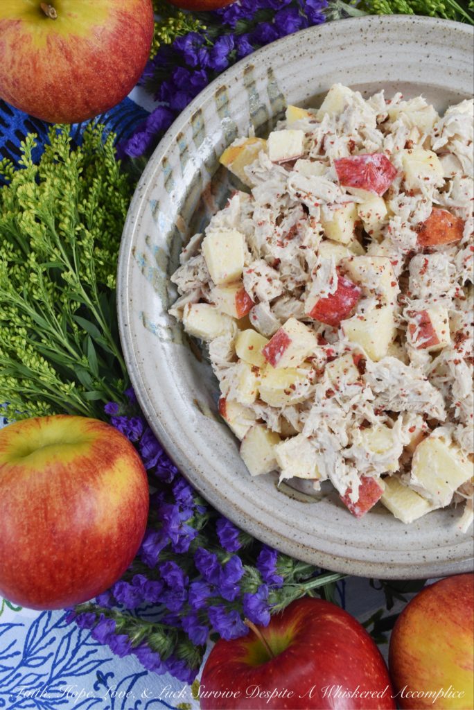 Pink Peppercorn & Curry Leaf Chicken Salad - Pink peppercorns and dried curry leaves bring a unique and subtle flavor to this pink peppercorn and curry leaf autumn chicken salad. To start with, the chicken is poached in seasoned water inside of a crockpot or slow cooker, to ensure that it is moist and extra flavorful. Then, it is gently tossed into a mayonnaise and apple cider vinegar mixture along with crunchy fall apples and additional pink peppercorns.