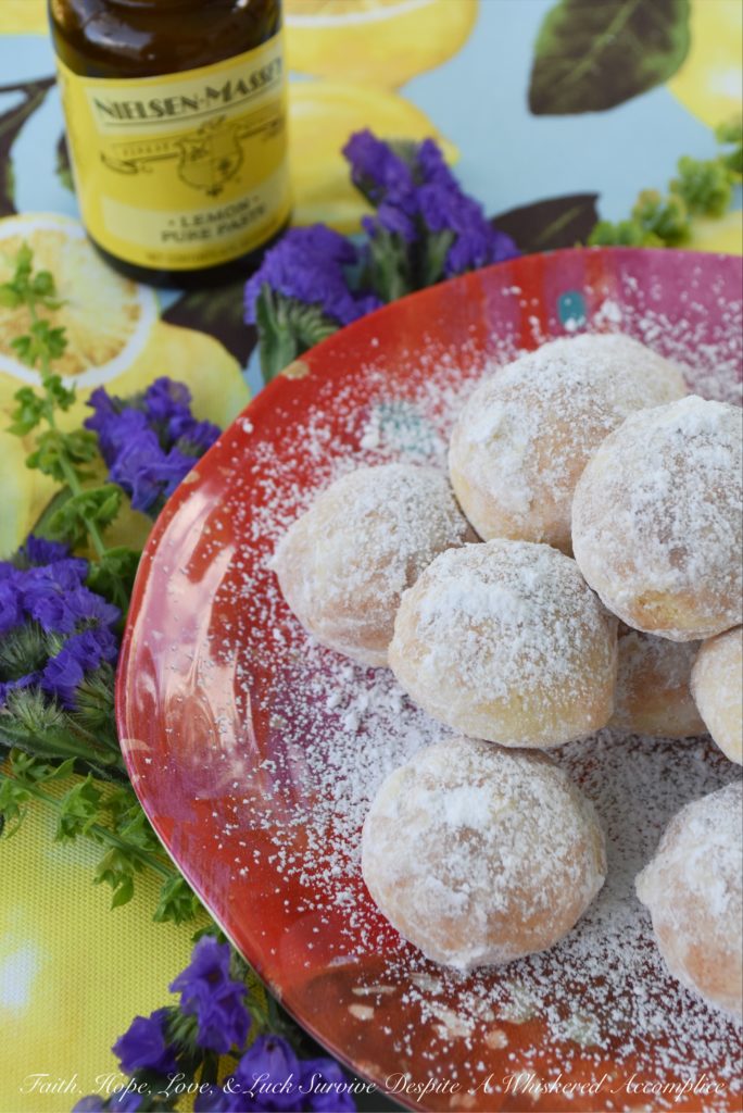 Powdered Sugar Lemon Tea Cookies - These delicate lemon cookies are the perfect cookie to serve alongside a hot cup of tea. Before baking, they're rolled in powdered sugar for an extra sweet flavor, and after baking, they're lightly dusted with powdered sugar to help make them look just as fabulous as they taste.