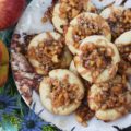 Buttery Apple Streusel Thumbprint Cookies - What's better than a cookie? A buttery cookie, filled with cinnamon caramel apple sauce, topped with sweet oatmeal streusel topping, and then drizzled with more cinnamon caramel apple sauce. Are you drooling yet? I know I am. Really, this is simply one thumbprint cookie you just have to make this fall.