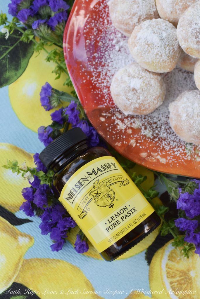 Powdered Sugar Lemon Tea Cookies - These delicate lemon cookies are the perfect cookie to serve alongside a hot cup of tea. Before baking, they're rolled in powdered sugar for an extra sweet flavor, and after baking, they're lightly dusted with powdered sugar to help make them look just as fabulous as they taste.