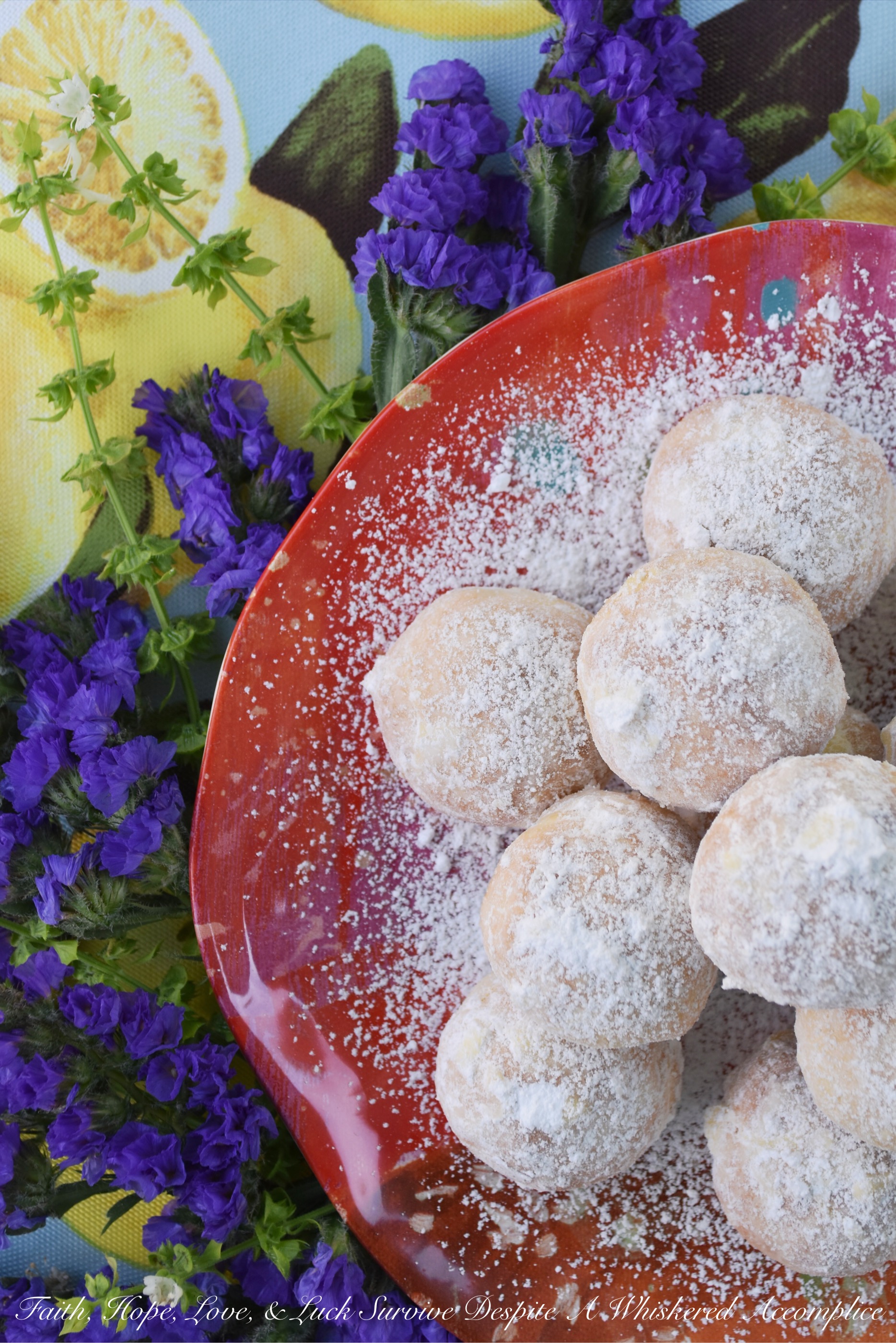 Powdered Sugar Lemon Tea Cookies - These delicate lemon cookies are the perfect cookie to serve alongside a hot cup of tea. Before baking, they're rolled in powdered sugar for an extra sweet flavor, and after baking, they're lightly dusted with powdered sugar to help make them look just as fabulous as they taste.