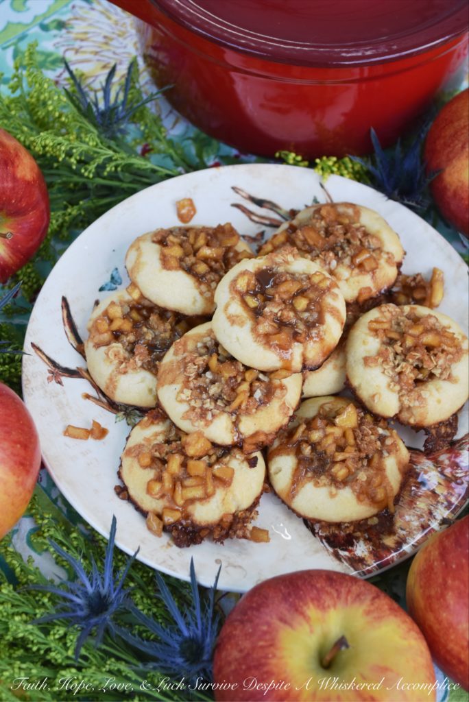 Buttery Apple Streusel Thumbprint Cookies - What's better than a cookie? A buttery cookie, filled with cinnamon caramel apple sauce, topped with sweet oatmeal streusel topping, and then drizzled with more cinnamon caramel apple sauce. Are you drooling yet? I know I am. Really, this is simply one thumbprint cookie you just have to make this fall.