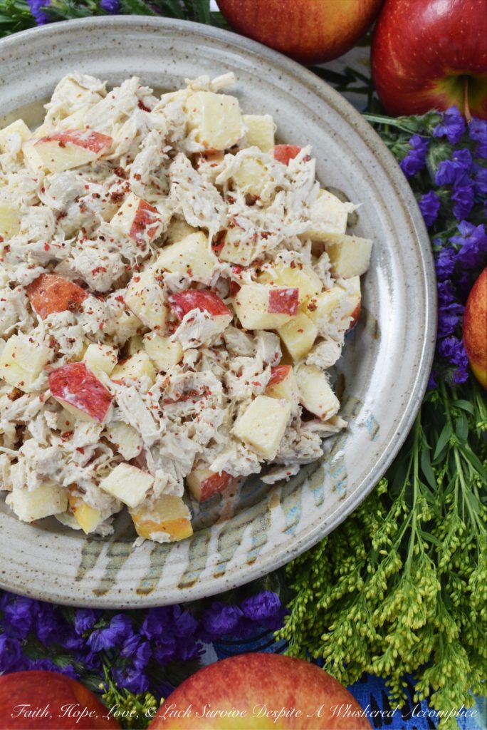 Pink Peppercorn & Curry Leaf Chicken Salad - Pink peppercorns and dried curry leaves bring a unique and subtle flavor to this pink peppercorn and curry leaf autumn chicken salad. To start with, the chicken is poached in seasoned water inside of a crockpot or slow cooker, to ensure that it is moist and extra flavorful. Then, it is gently tossed into a mayonnaise and apple cider vinegar mixture along with crunchy fall apples and additional pink peppercorns.