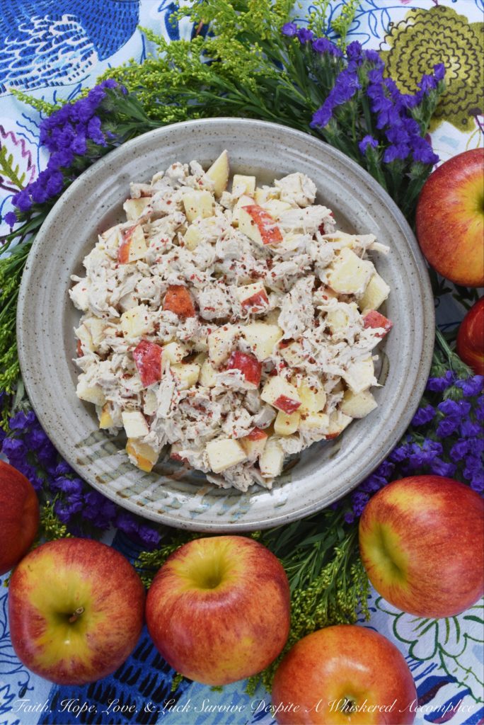 Pink Peppercorn & Curry Leaf Chicken Salad - Pink peppercorns and dried curry leaves bring a unique and subtle flavor to this pink peppercorn and curry leaf autumn chicken salad. To start with, the chicken is poached in seasoned water inside of a crockpot or slow cooker, to ensure that it is moist and extra flavorful. Then, it is gently tossed into a mayonnaise and apple cider vinegar mixture along with crunchy fall apples and additional pink peppercorns.