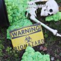 Biohazard Hazardous Waste Halloween Skeletons - Each year The Historic Herndon Halloween House chooses a new theme when it comes to decorating the graveyard. This year, the theme is biohazard hazardous waste, so our poor Skeleton Clan Army was forced to flee in fear. They're running and jumping over fences in an attempt to escape the evil HAZMAT Skeletons.