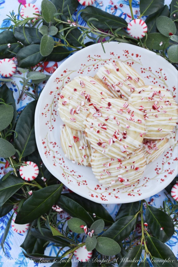 White Christmas Peppermint Holiday Cookies - Not only do these peppermint holiday cookies practically melt in your mouth, but due to their flaky texture, they almost crumble apart at the gentlest touch. Thankfully the white chocolate they are drizzled with helps keep them together just long enough for you to get them from your hand to your mouth. Sure there may be a few crumbs dropped during the process, but who can't live with a few crumbs at Christmas time?