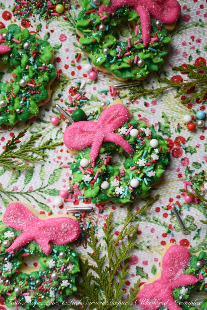 Whoville Christmas Wreath Sugar Cookies - All the little Whos in Whoville will simply adore these Whoville Christmas Wreath Sugar Cookies. To decorate these vivid green and pink buttercream icing frosted Christmas sugar cookies, simply break out your brightest and most whimsical sprinkles. When it comes to decorating these Christmas wreaths, there's no need to be a Grinch, don't hold back. In this case, more sprinkles is definitely a good thing.