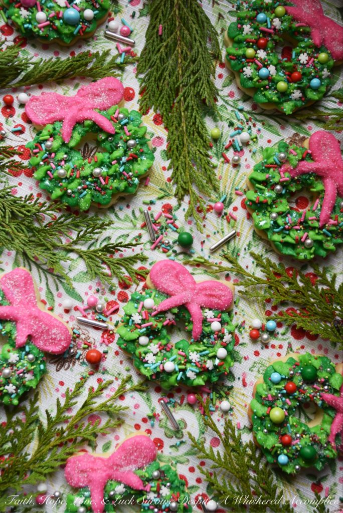 Whoville Christmas Wreath Sugar Cookies - All the little Whos in Whoville will simply adore these Whoville Christmas Wreath Sugar Cookies. To decorate these vivid green and pink buttercream icing frosted Christmas sugar cookies, simply break out your brightest and most whimsical sprinkles. When it comes to decorating these Christmas wreaths, there's no need to be a Grinch, don't hold back. In this case, more sprinkles is definitely a good thing.