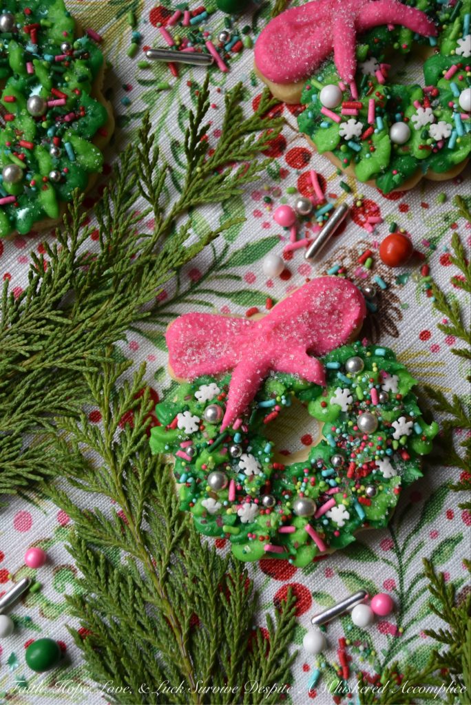 Whoville Christmas Wreath Sugar Cookies - All the little Whos in Whoville will simply adore these Whoville Christmas Wreath Sugar Cookies. To decorate these vivid green and pink buttercream icing frosted Christmas sugar cookies, simply break out your brightest and most whimsical sprinkles. When it comes to decorating these Christmas wreaths, there's no need to be a Grinch, don't hold back. In this case, more sprinkles is definitely a good thing.