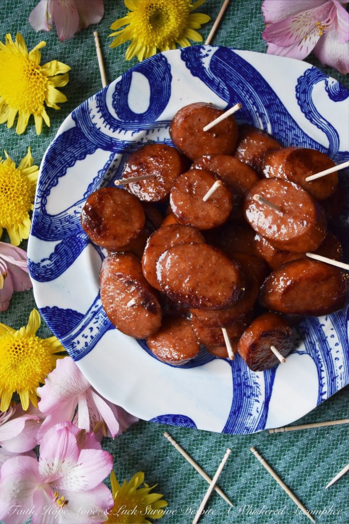 Soda Glazed Kielbasa Game Day Bites - These sweet and spicy soda glazed Polish kielbasa appetizers are made using one pan, take less than 20 minutes to make, and are sure to be a huge hit at your next football party. Soda, brown sugar, cayenne pepper, and a few other seasonings give these little game day bites a real flavor kick that your guests will absolutely love. Now, if only the Super Bowl commercials are half as good, we'll really have something to celebrate.