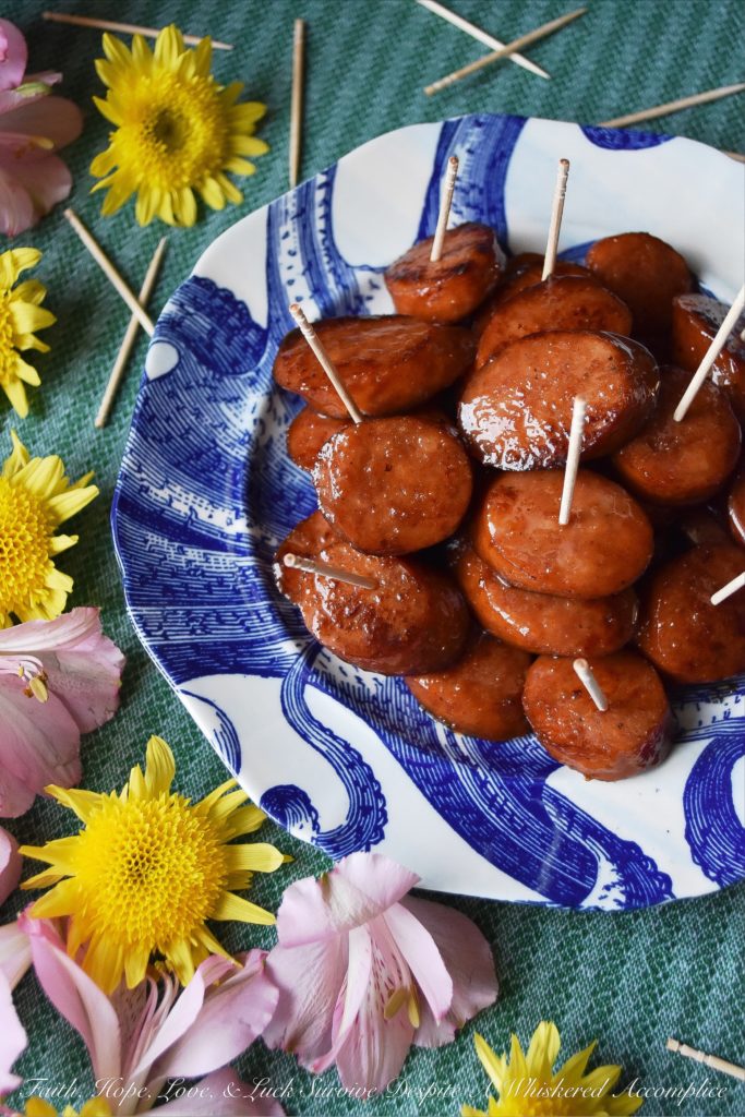 Soda Glazed Kielbasa Game Day Bites - These sweet and spicy soda glazed Polish kielbasa appetizers are made using one pan, take less than 20 minutes to make, and are sure to be a huge hit at your next football party. Soda, brown sugar, cayenne pepper, and a few other seasonings give these little game day bites a real flavor kick that your guests will absolutely love. Now, if only the Super Bowl commercials are half as good, we'll really have something to celebrate.