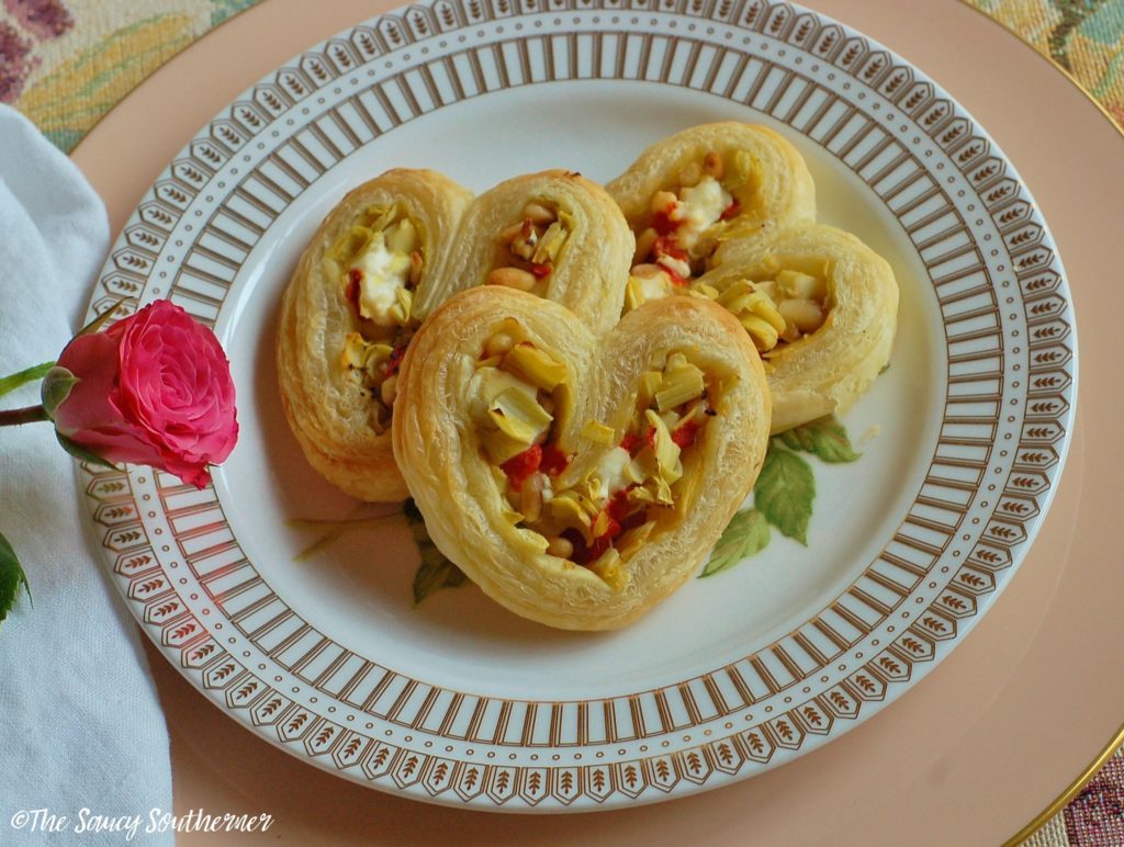 Artichoke Heart Savory Palmier - The Saucy Southerner - Valentine's Day is all about sweet treats, chocolate, and romantic dinners. So, join us this February for our recipe round-up, where we celebrate some of our favorite love-inspiring recipes in celebration of the upcoming holiday.