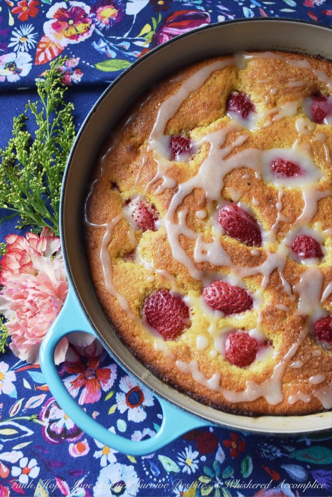 Sweet Strawberry Honey Cornbread Cake - This honey-flavored cast iron cornbread cake is full of sweet strawberries and topped with just the right amount of powdered sugar drizzle. Whether you choose to serve it for breakfast alongside a banana or additional sliced strawberries, or for dessert alongside fresh whipped cream or a scoop of ice cream, I guarantee that you'll fall absolutely in love with this sweet cornbread after the very first bite.
