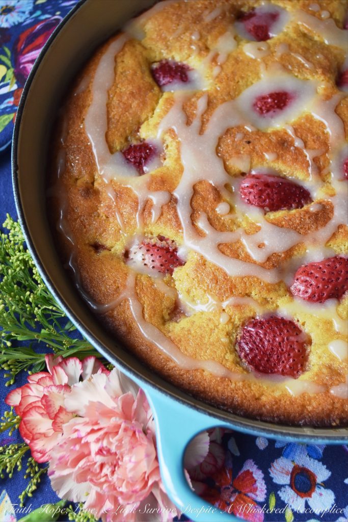 Sweet Strawberry Honey Cornbread Cake - This honey-flavored cast iron cornbread cake is full of sweet strawberries and topped with just the right amount of powdered sugar drizzle. Whether you choose to serve it for breakfast alongside a banana or additional sliced strawberries, or for dessert alongside fresh whipped cream or a scoop of ice cream, I guarantee that you'll fall absolutely in love with this sweet cornbread after the very first bite.